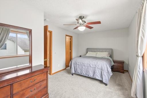 Upper level primary bedroom with walk-in closet