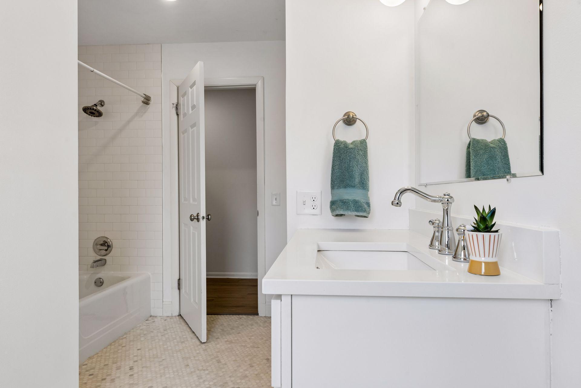 Spacious full bath, with original tub and floor to ceiling tile.