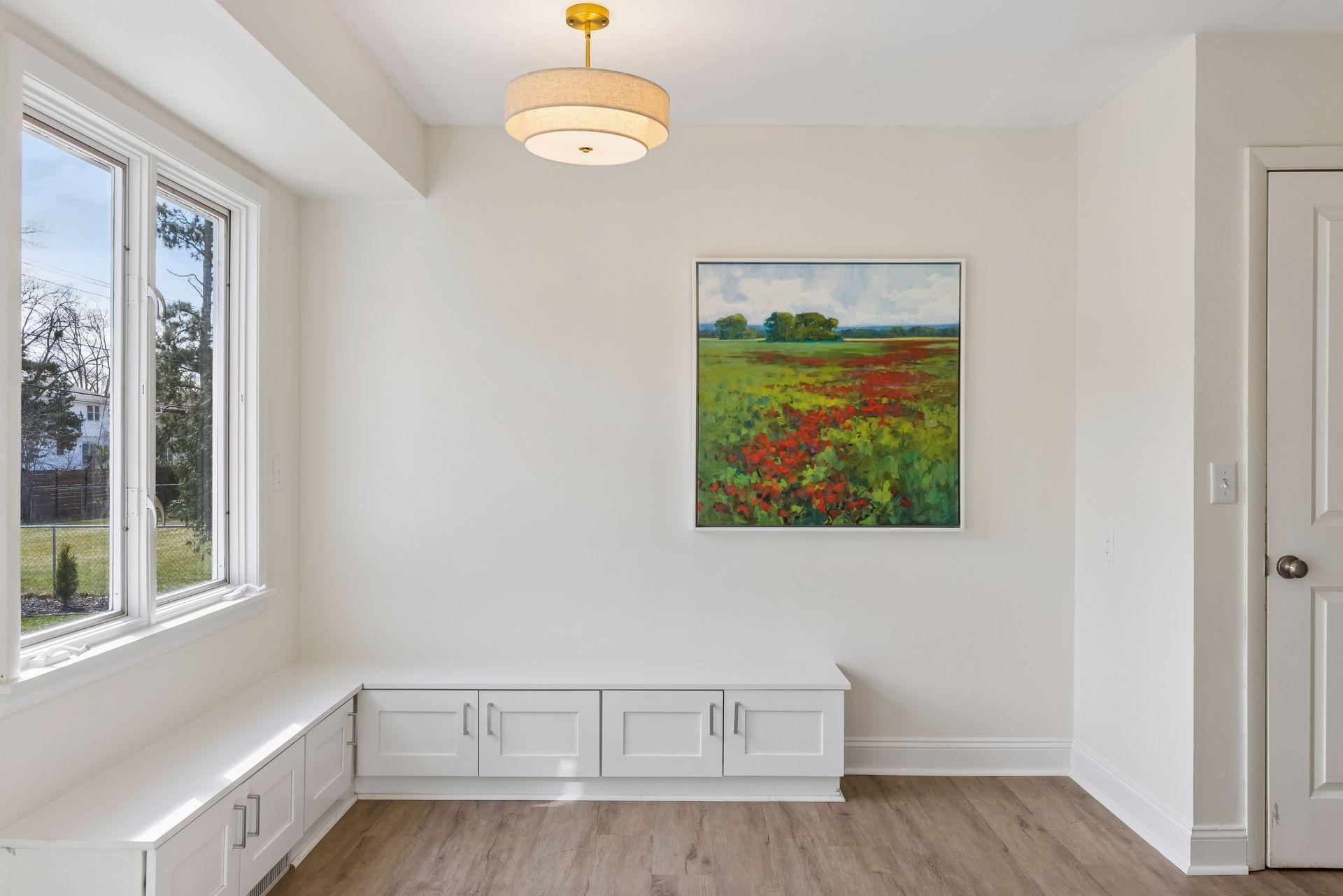 Kitchen corner breakfast nook, with LVP flooring and updated lighting.