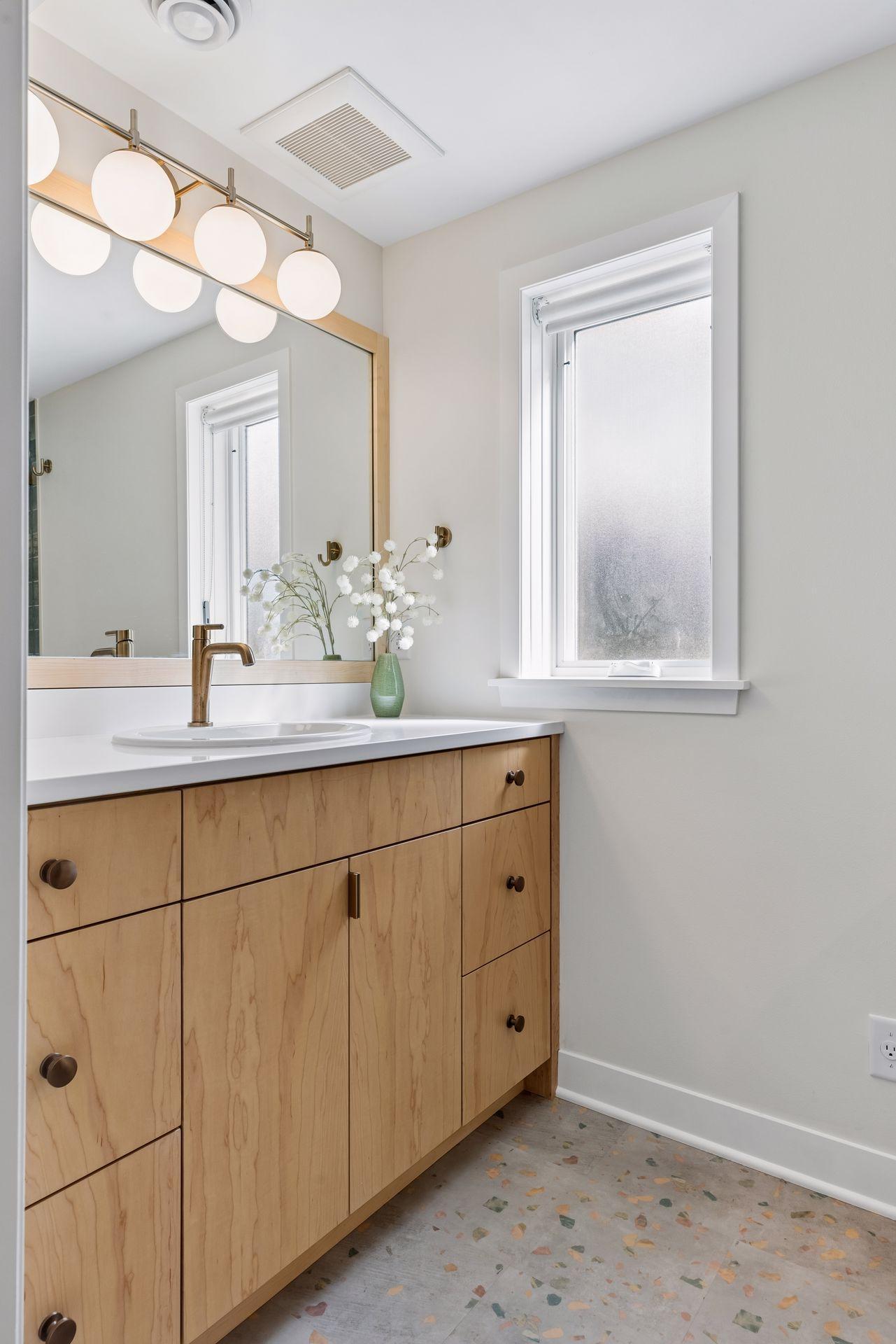 Brand new custom vanity with niche storage space, all new hardware, lighting, flooring and windows.