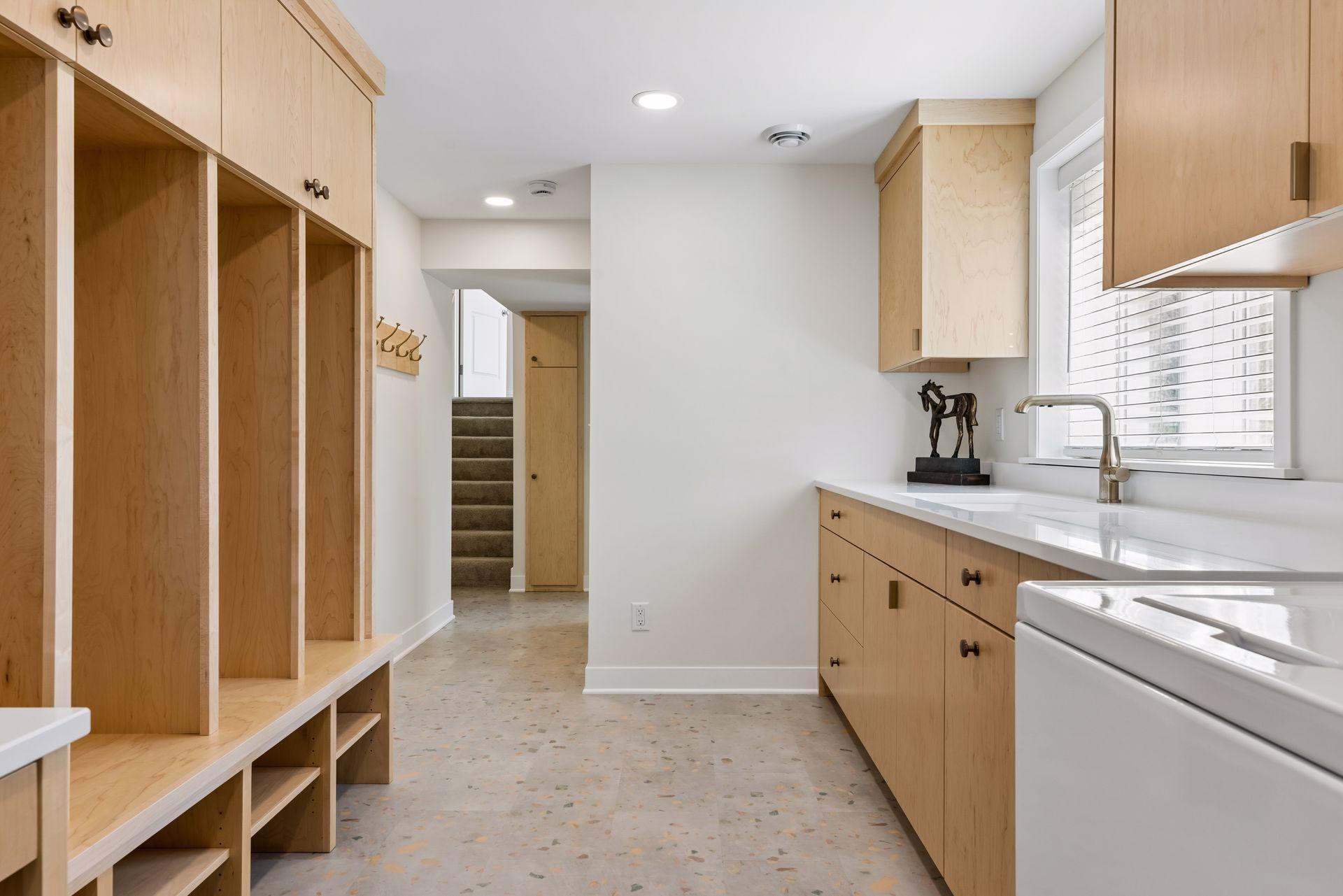 Fully-custom remodeled mudroom and laundry area by Sicora is all about beautiful functionality.