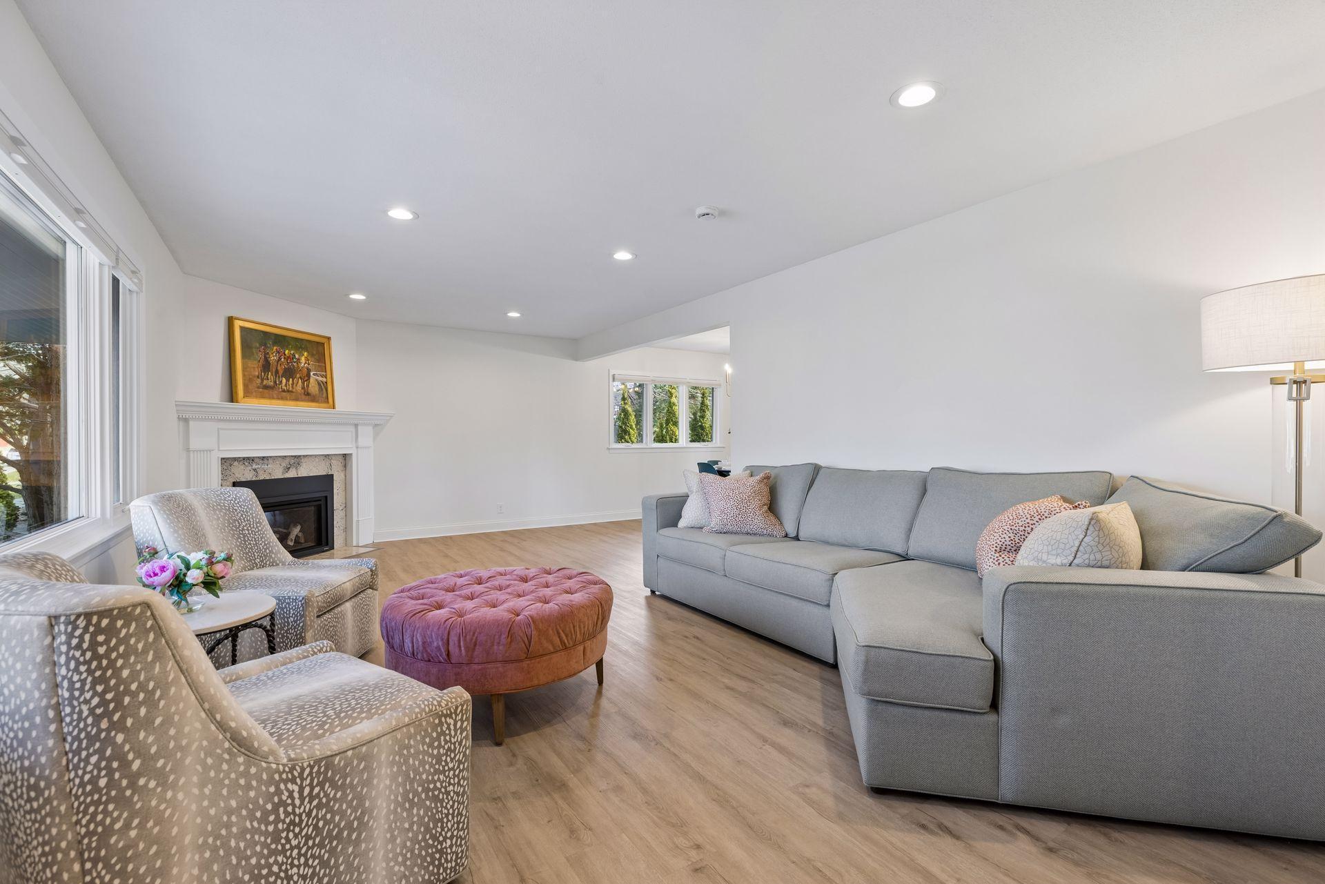 Inviting main level living room with views of the covered front patio through new Marvin windows.