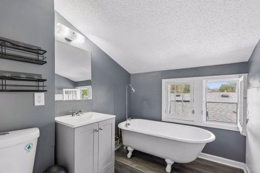 Upper level private en suite bath with claw foot tub.