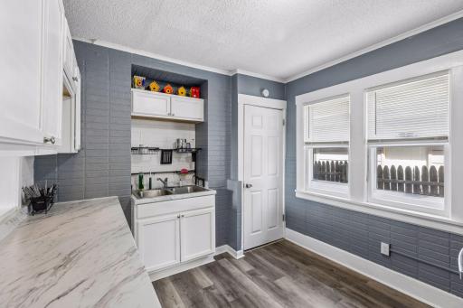 Cute cottage style kitchen with white cabinetry.