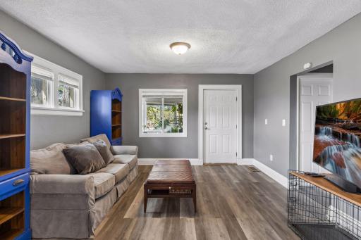 Bright and airy living room. Main floor offers fresh wall paint and LVP flooring.