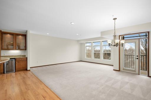 Roomy living room with lots of natural light and private wooded view overlooking the creek