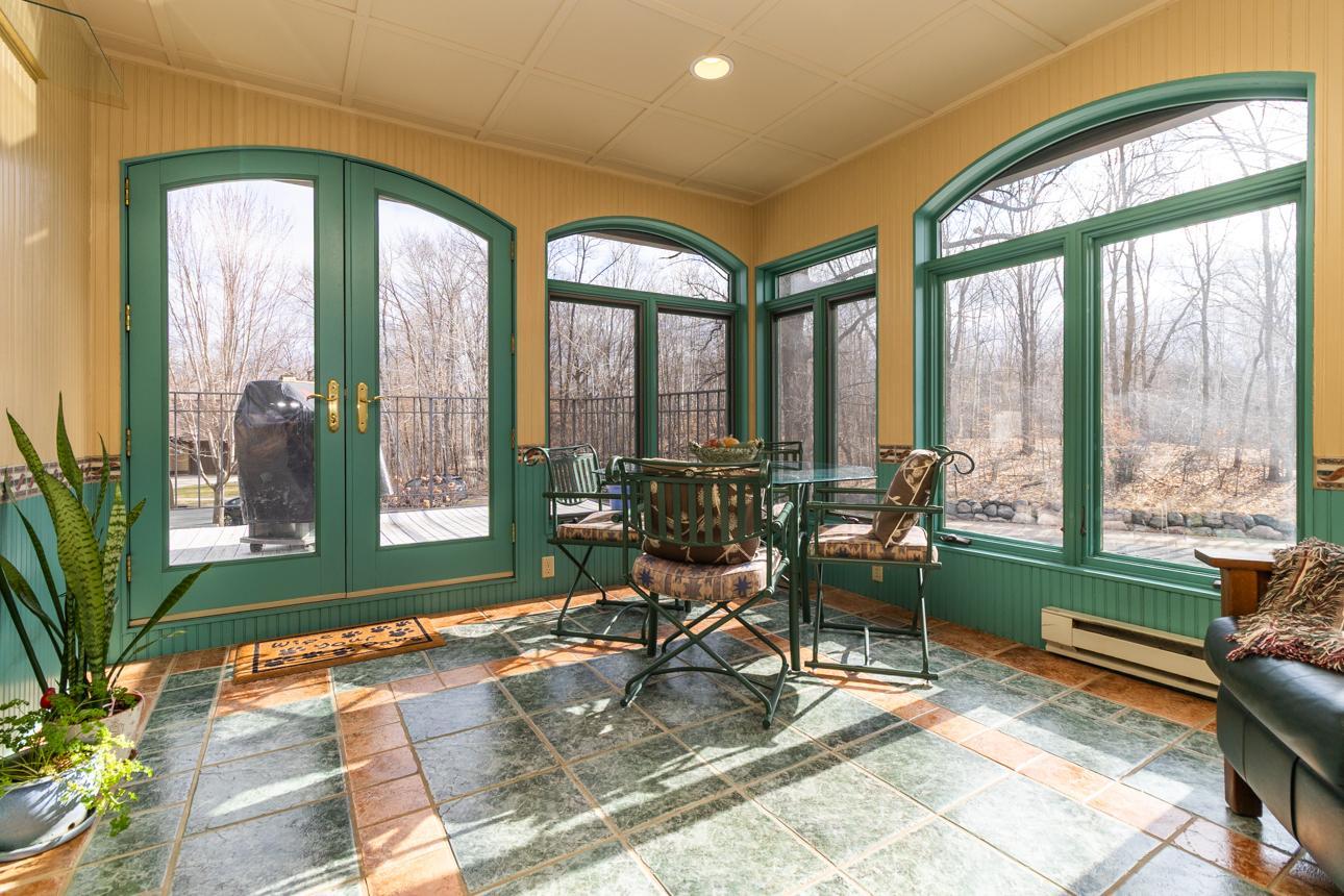 Four season porch off the formal dining room with access to the deck.