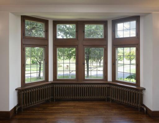 Handsome bay windows in living room overlooking Lake of the Isles