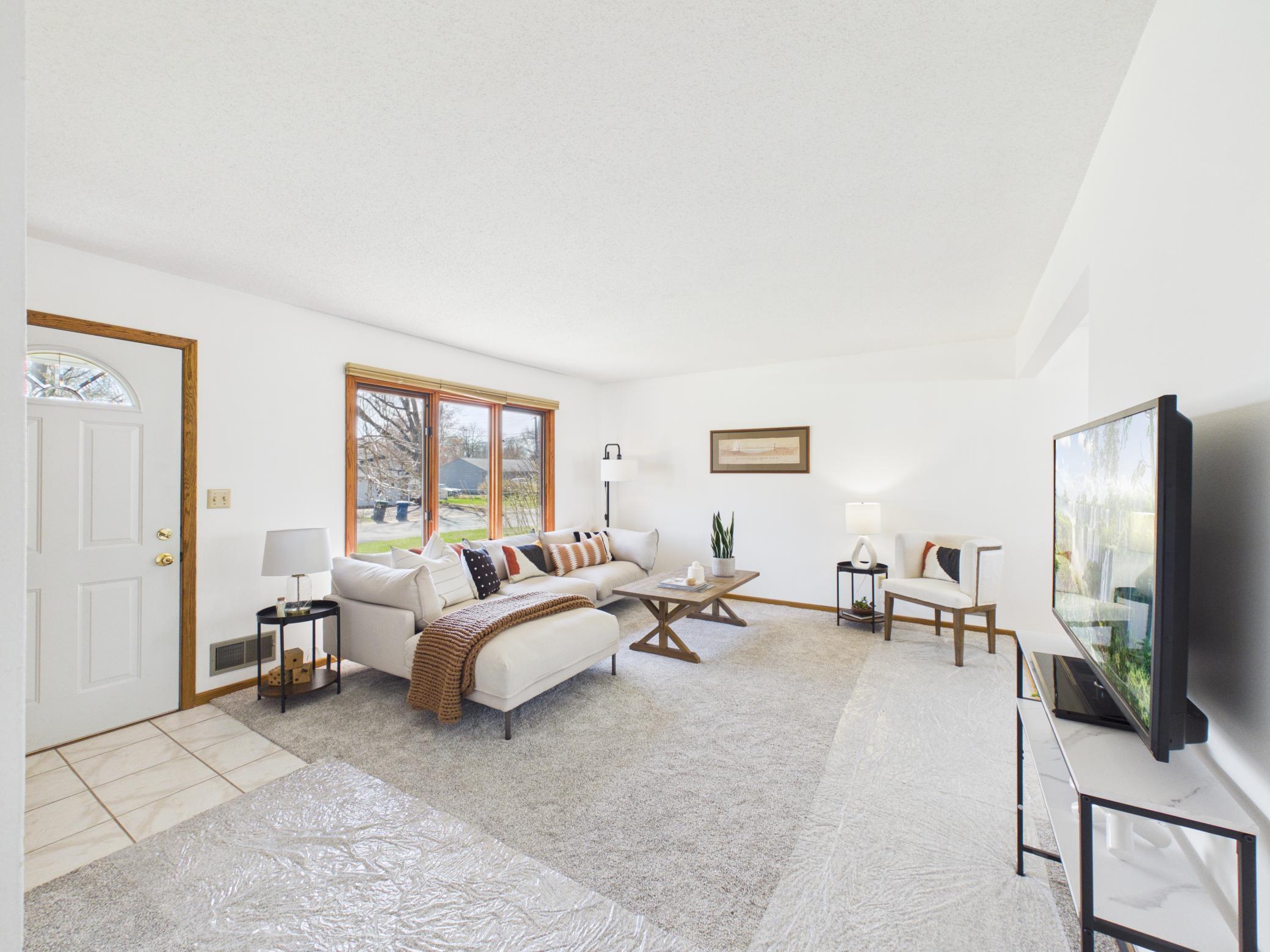 Today the living room has been freshly painted with plush new carpet (plastic for protection).