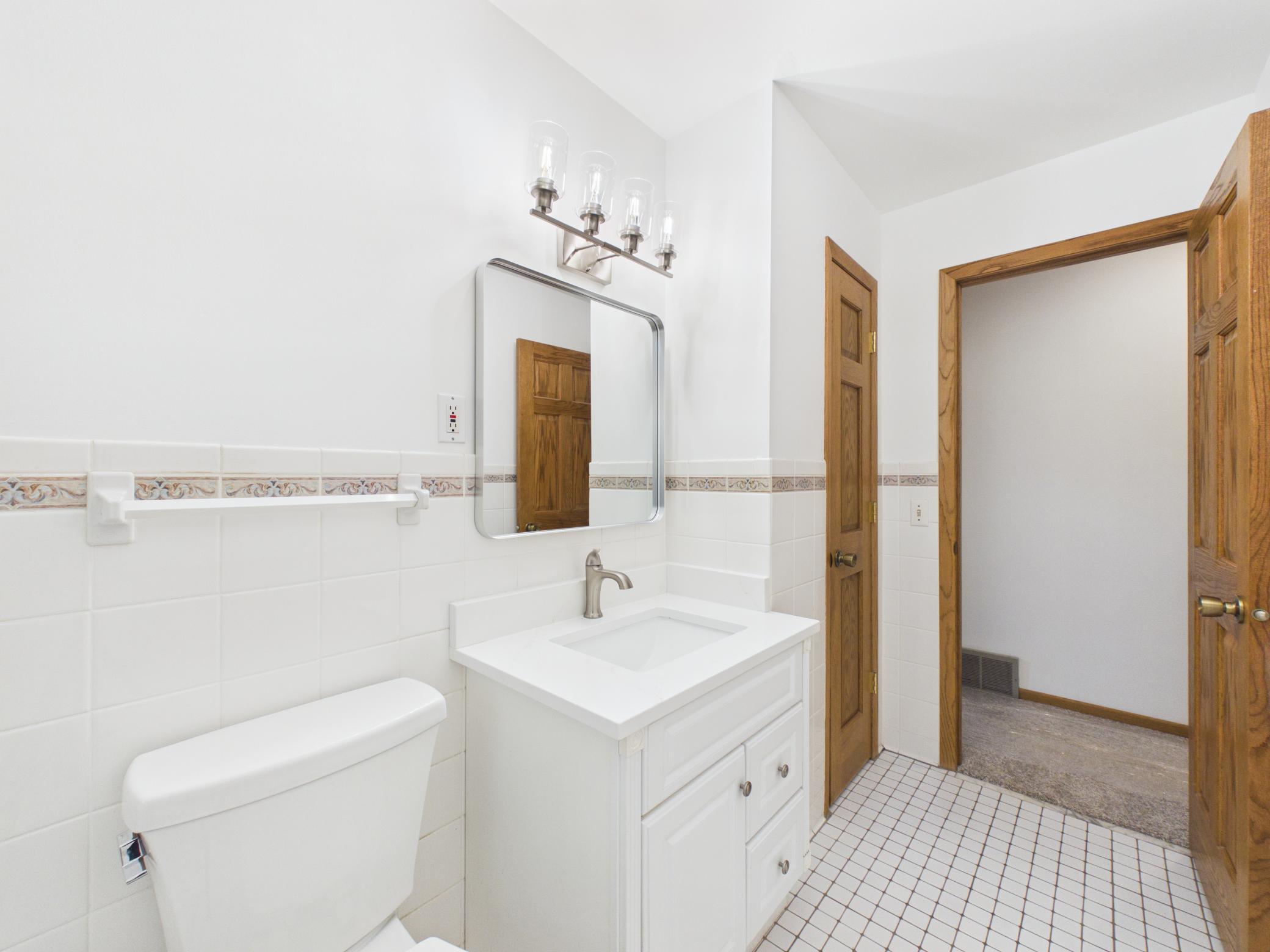 New quartz countertop, mirror, and and lighting make getting ready a breeze.