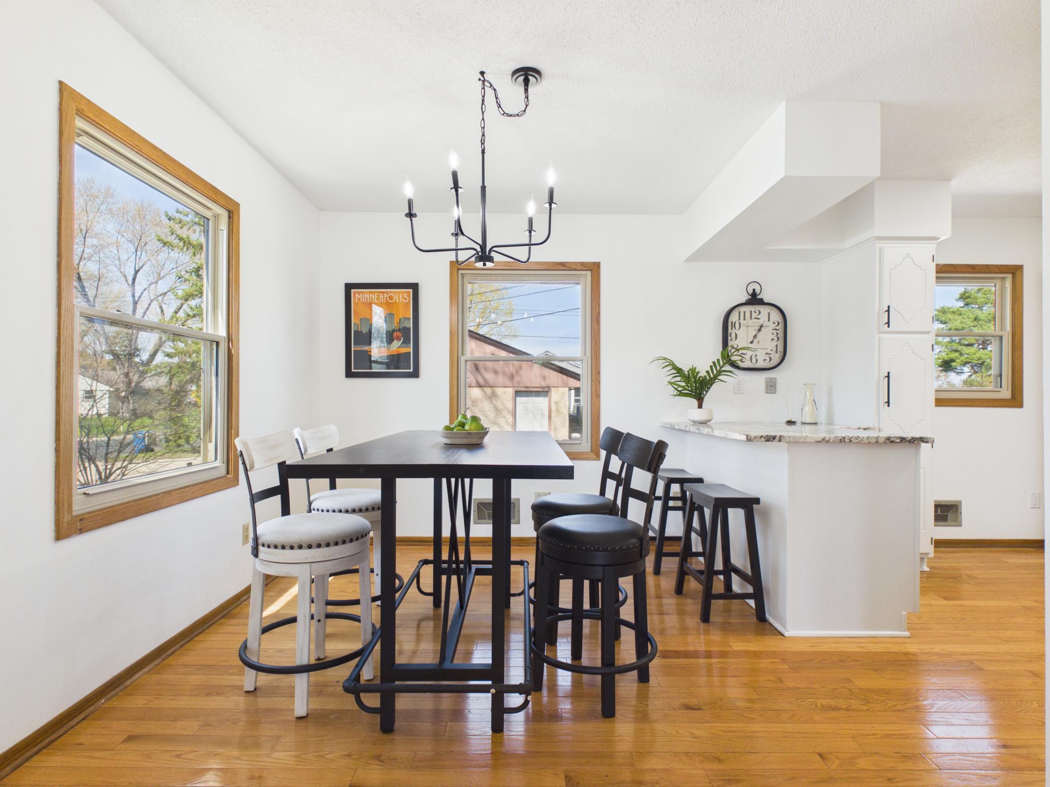 A modern chandelier illuminates the dining room that in the dining room, as well as the kitchen and baths.