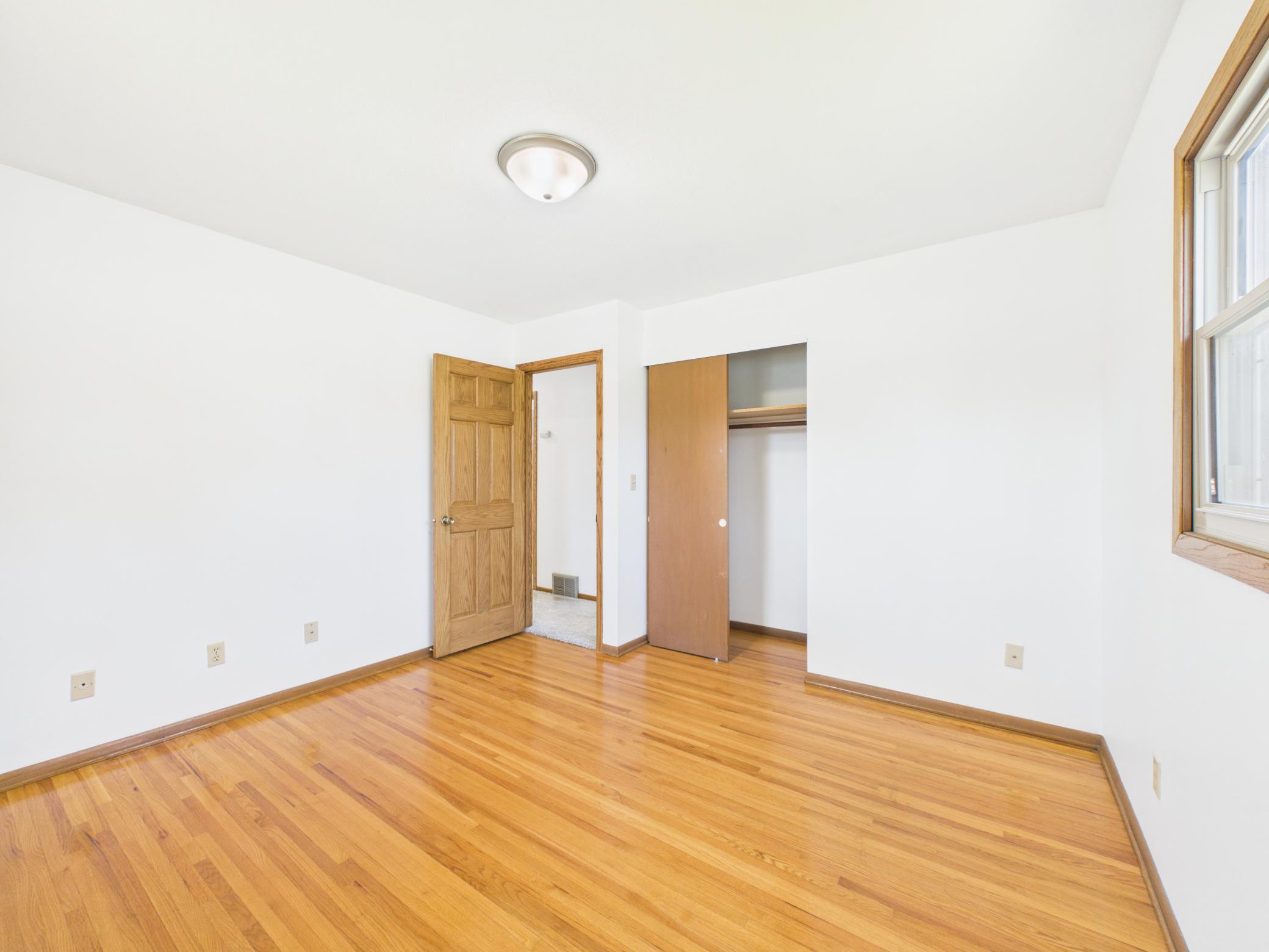 Original hardwood floors shine in all three bedrooms.