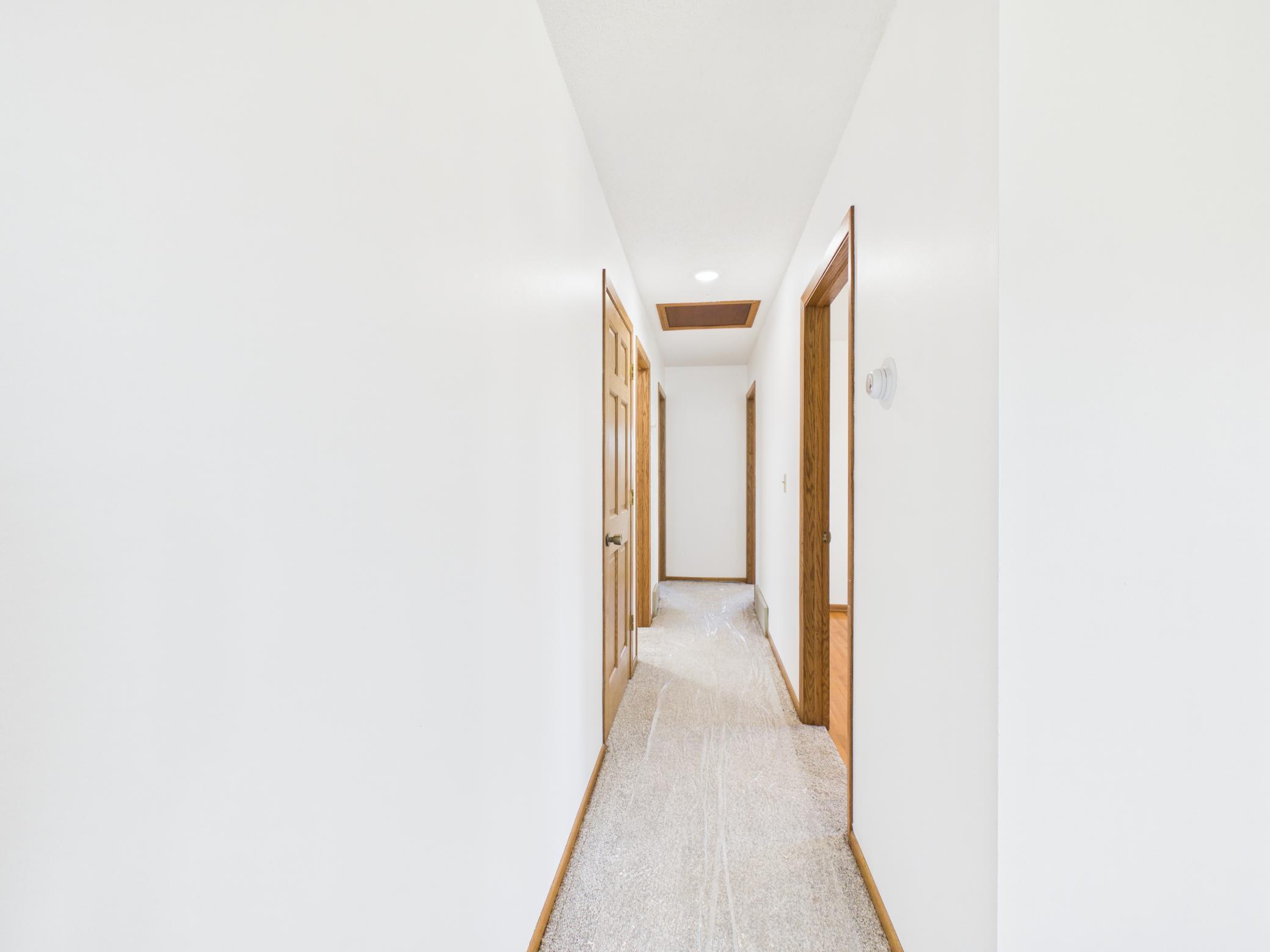 Bedrooms and bath are tucked away from the kitchen and dining, situated on the opposite side of the living room.