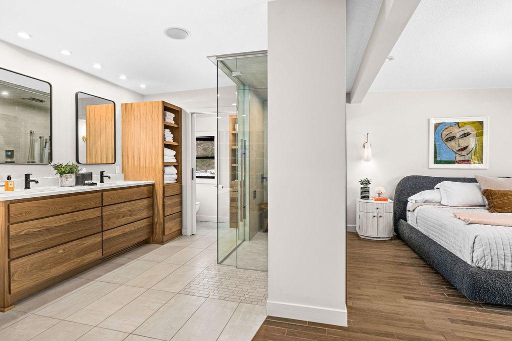 Step into the luxurious primary bathroom which features new custom cabinets, countertops, new windows, and custom window shades.