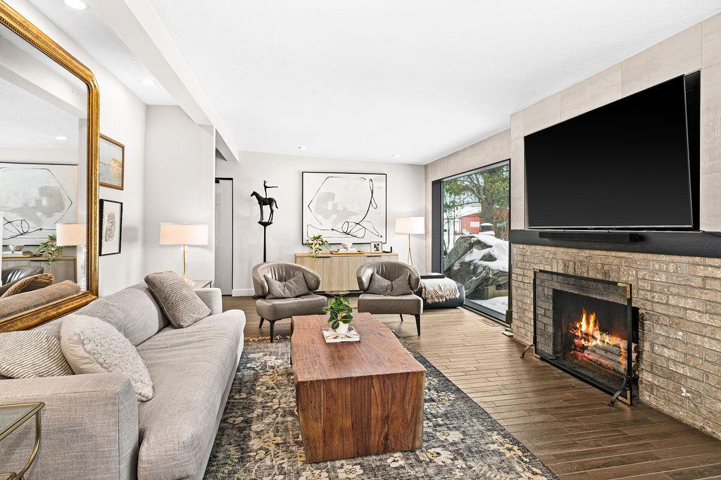 This room is lit by the oversized windows with a great view.