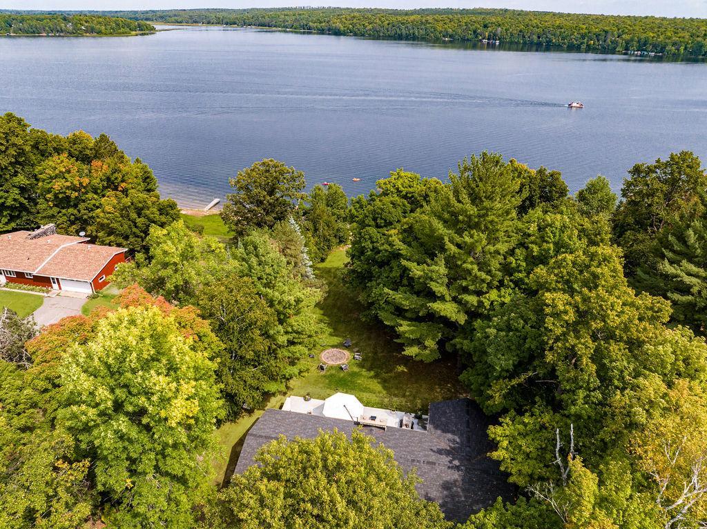 The property features 130 feet of pristine sandy beach