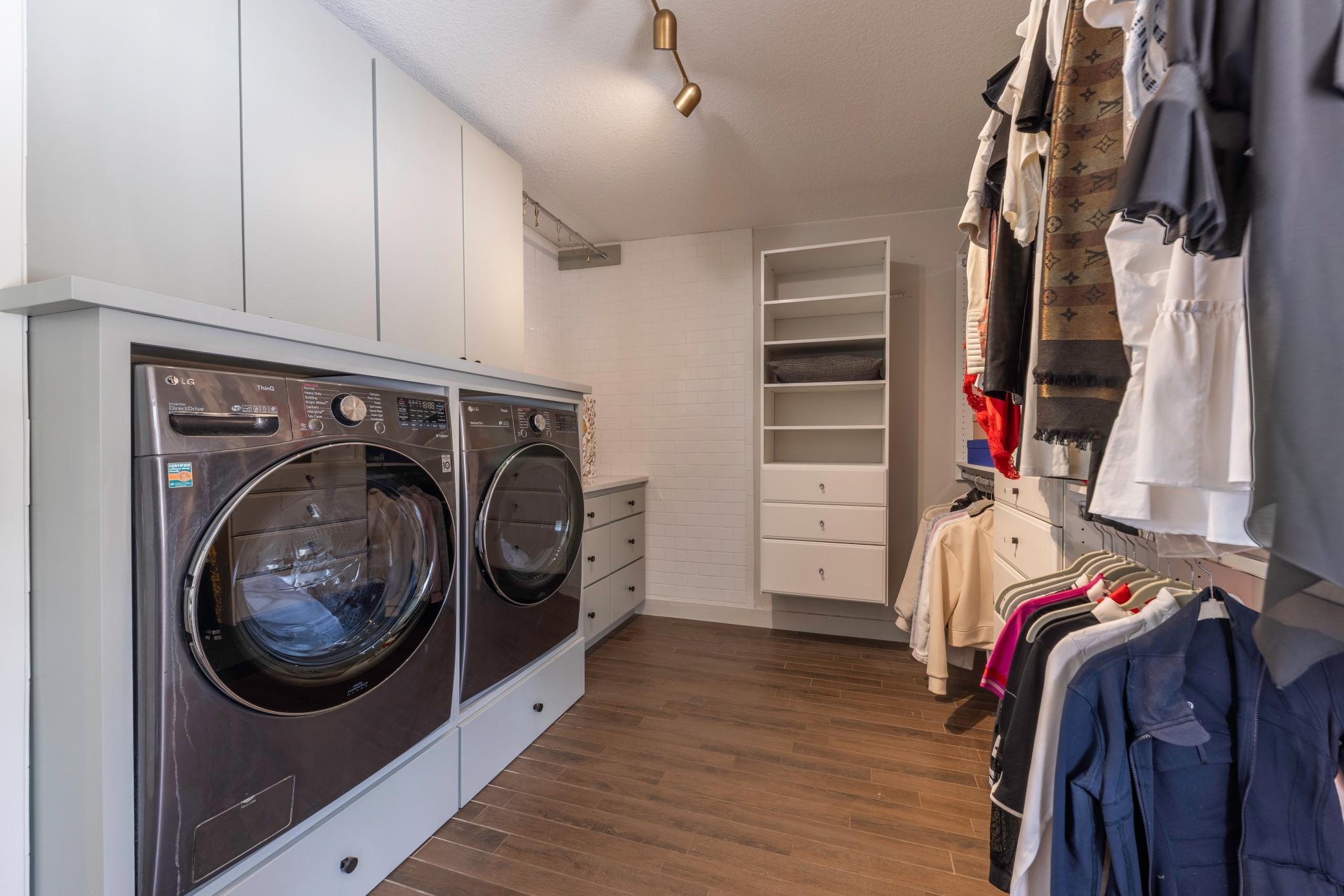 Laundry room with a sink, counter space, and extra closet space.