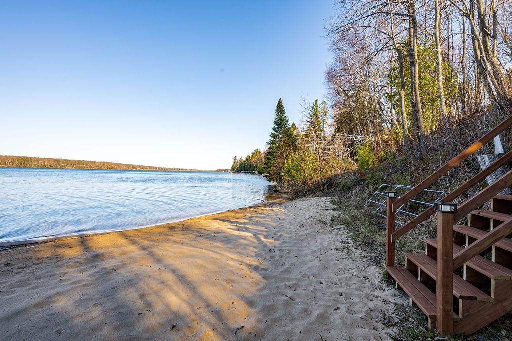 Step down the stairs and sink your toes into the soft, sandy beach