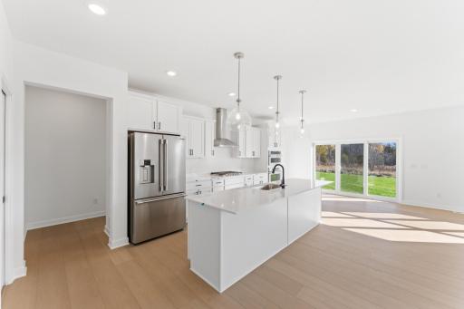 (Photo of an inventory home, actual homes finishes will vary) Soaked in natural sunlight, the home's eat-in dining room has ample space.