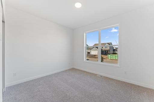 (Photo of an inventory home, actual homes finishes will vary) One of two secondary bedrooms.