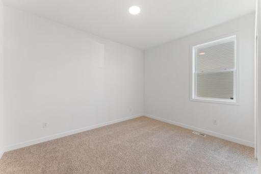 (Photo of an inventory home, actual homes finishes will vary) One of two secondary bedrooms.