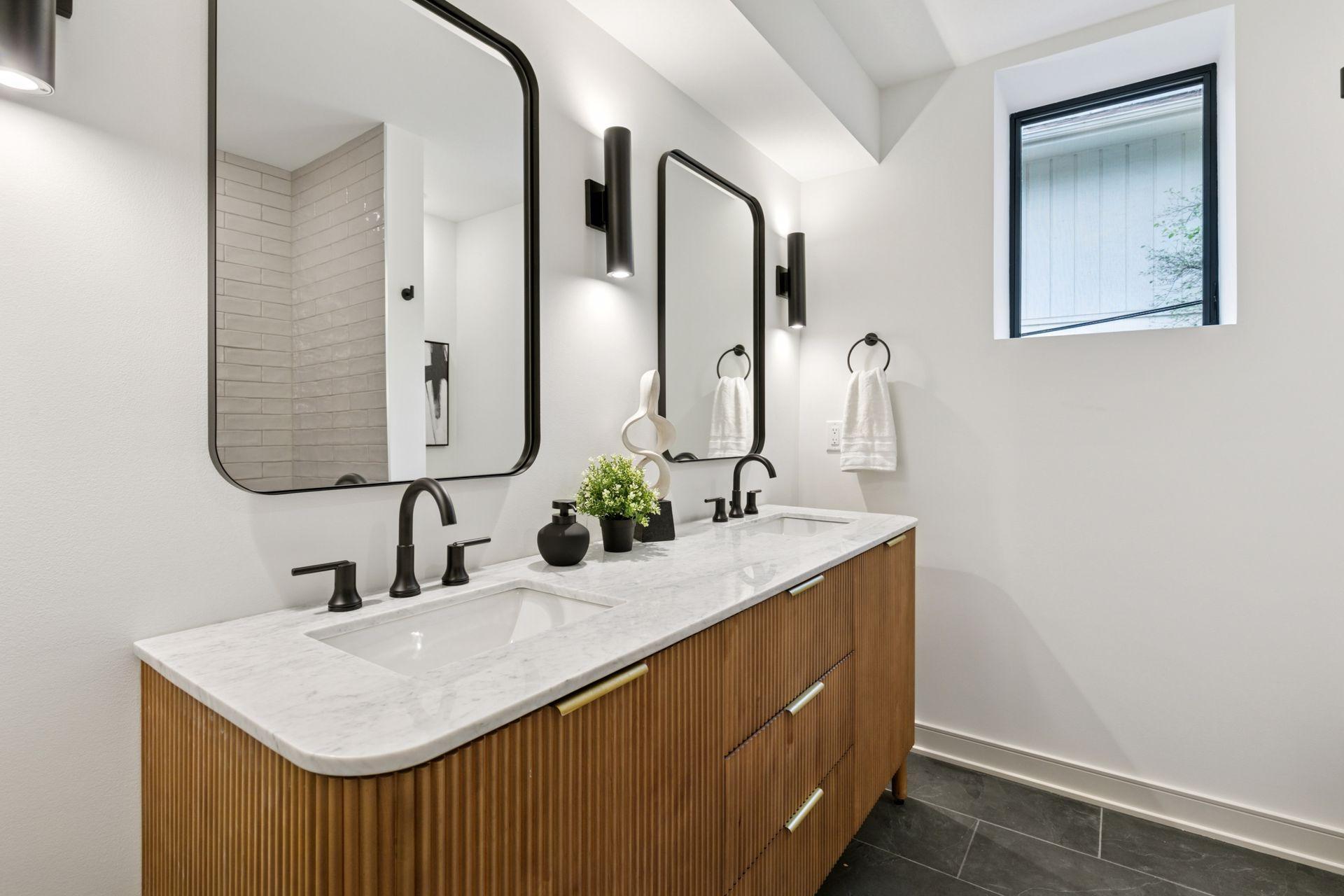The lower level bath -Retro Perla Ceramic Tiles, Montauk Slate heated floors, a double vanity with custom hardware and lighting