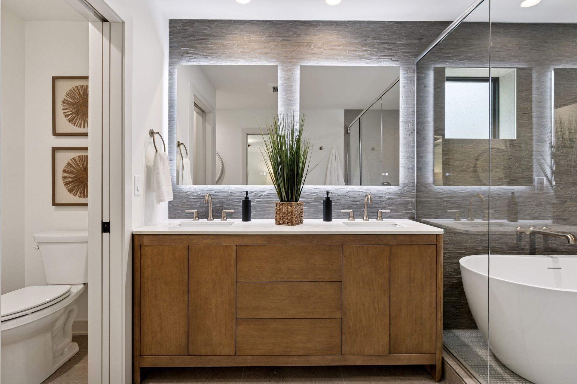 Beautiful custom cabinetry, a double vanity with backlit custom mirrors - beautiful.