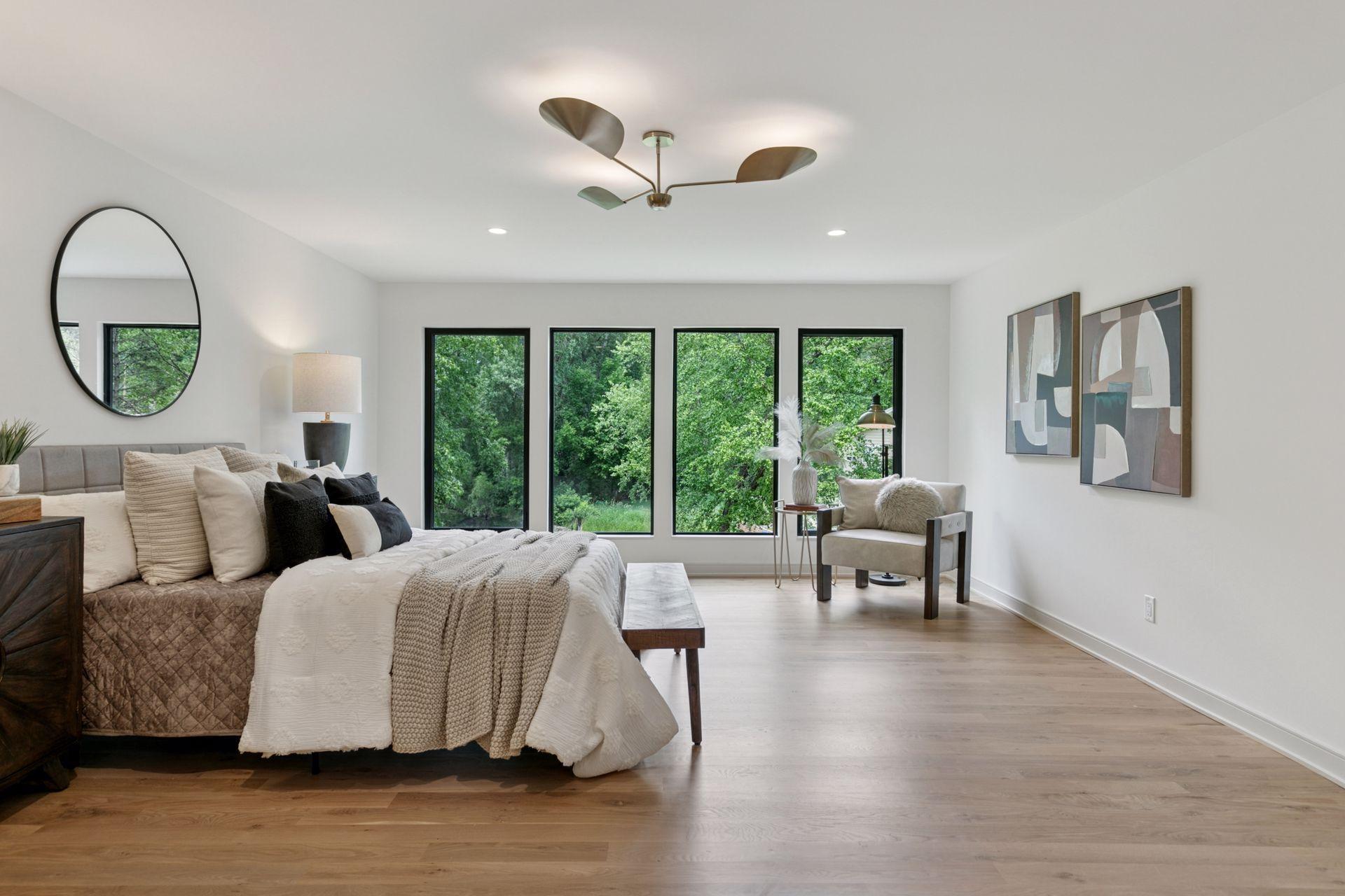 The quiet tucked away expansive primary suite overlooks the backyard and pond