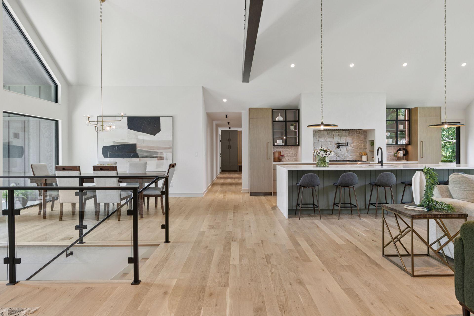 Iron and glass complement the expansive White Oak Floors