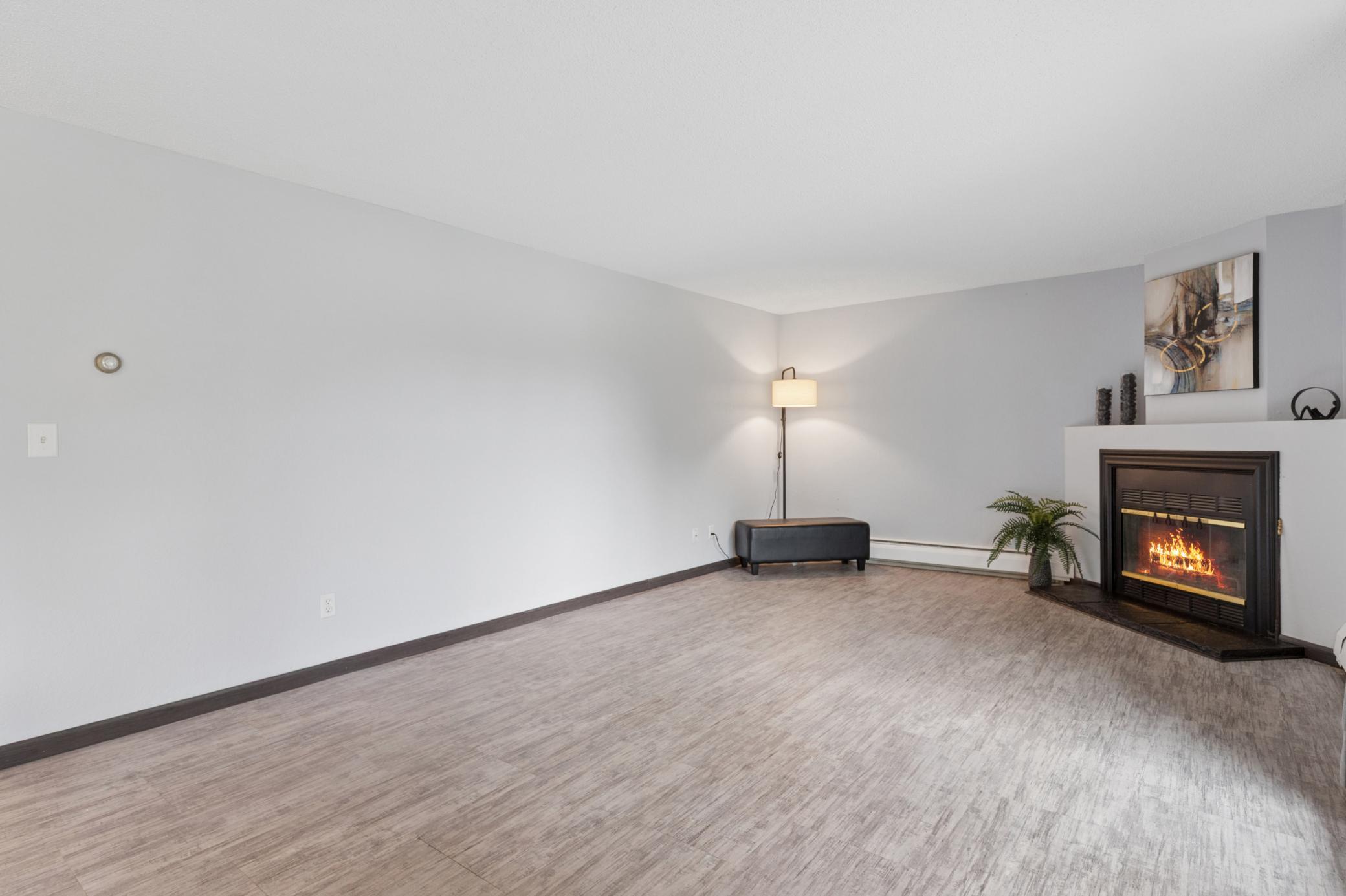 Freshly painted ceilings, walls, newer floors, outlets, and a lovely wood burning fireplace! Spacious!