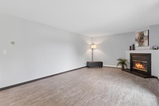 Freshly painted ceilings, walls, newer floors, outlets, and a lovely wood burning fireplace! Spacious!