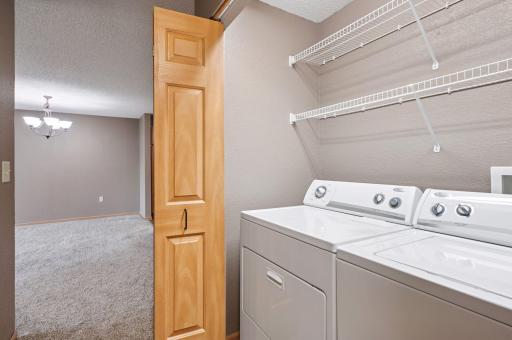 In unit laundry includes shelves for easy laundry and cleaning supply storage.