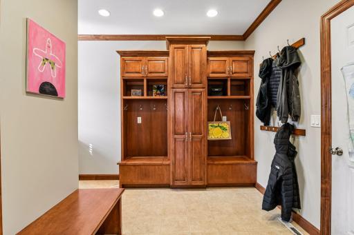 Behind the kitchen is the ESSENTIAL room with 1/2 bath, built-in desk w/window, lockers w/hinged benches, storage cabinets, shoe niches, recessed lighting, coat hooks...just what you have dreamed of! Plus it leads to the best garage for miles!