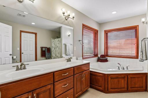 Here you can see the double sink vanity and the door to the 8' X 6' walk-in closet is reflected in the mirror.
Nice natural light from the corner windows...