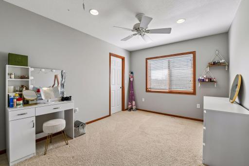 This bedroom has a walk-in closet. The view is over the back yard.