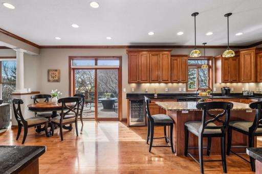 An island seats 3, a table by the transom topped patio door easily seats 4. A wine refrigerator is at the end of the counter near the patio door that leads to the 18 X 16 deck. Check out the under cabinet lighting.