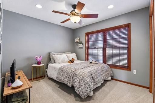 One of the three remaining bedrooms, this one looks out over the front yard. All three junior bedrooms have ceiling fan lights and recessed lights.