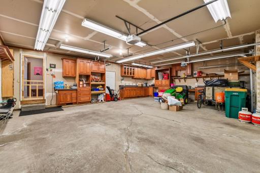 An oversized 760 sf garage has loads of built-in cabinets and storage, an ABUNDANCE of lighting, a screen door to the house plus a service door to the exterior. It is insulated and dry-walled.
