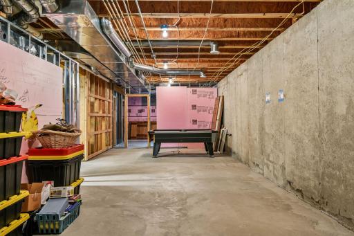 This shows what has been done in the poured concrete basement - lighting, some walls are framed, etc. You can see what you are buying. Generous electrical service provides in excess of 200 Amps.
A bathroom is roughed in. Egress window in future BR.