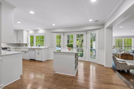 Large island seating, quartz hard surfaces, and French doors to the deck