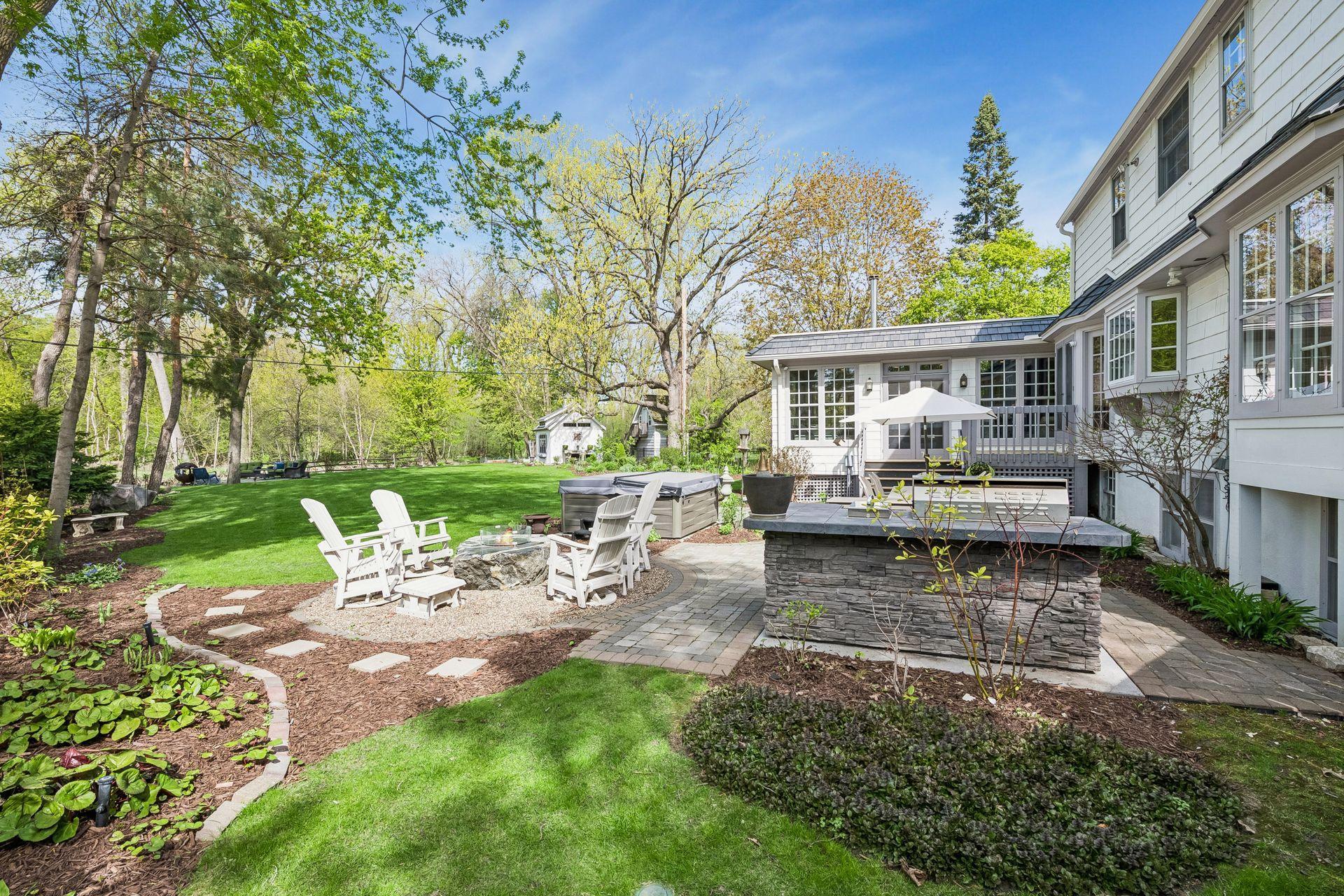 Outdoor kitchen, spa, and stone firepit