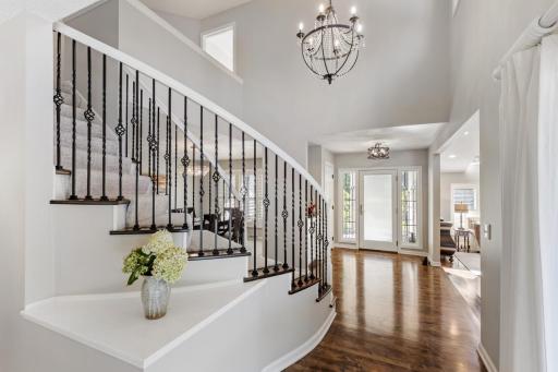 Light-filled foyer with rich hardwood floors and stunning stained-glass windows.