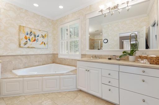 Primary ensuite with a jetted tub, walk-in shower, and separate vanities for added convenience.