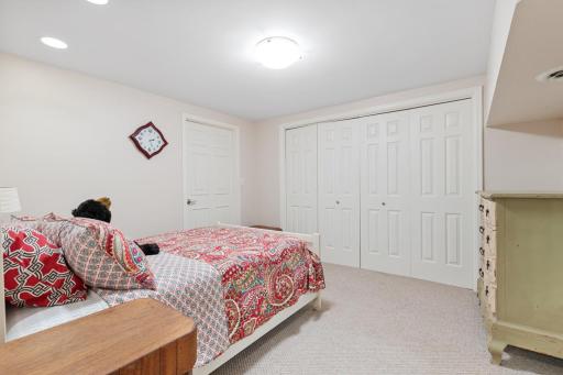 Generous lower-level bedroom featuring recessed lighting, a roomy closet, and access to the storage room(non-conforming)..