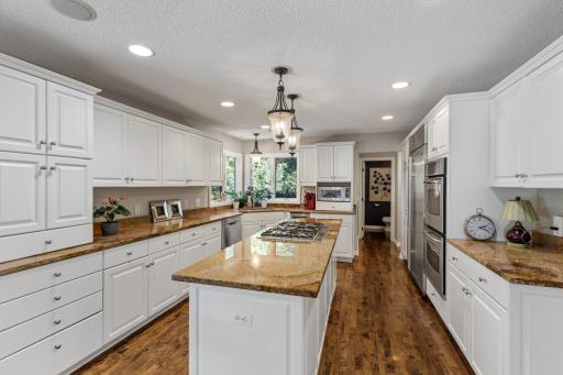 Chef-inspired main-level kitchen with recessed lighting and ample storage in beautiful white cabinetry.
