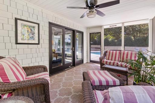 Spacious screened-in porch with walk-out access to the pool and backyard.