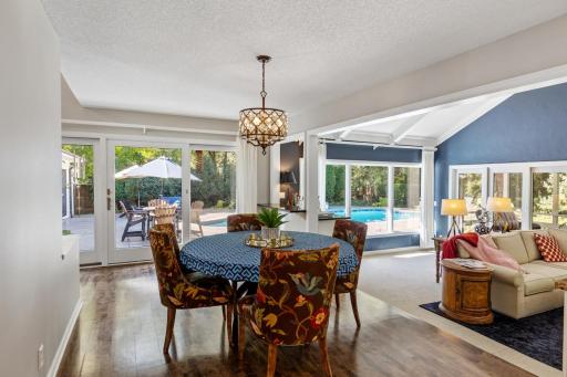 Informal dining area filled with natural light and direct access to the poolside patio.