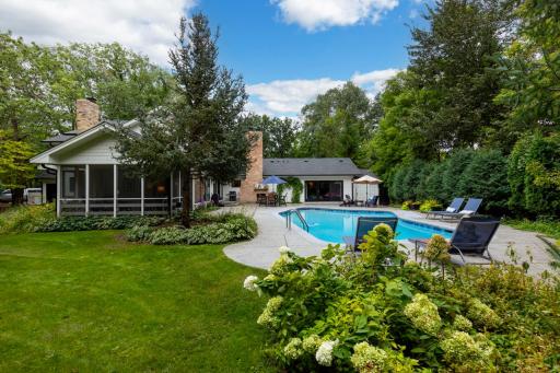 Resort-style backyard with a heated pool, patio, and exterior fireplace.