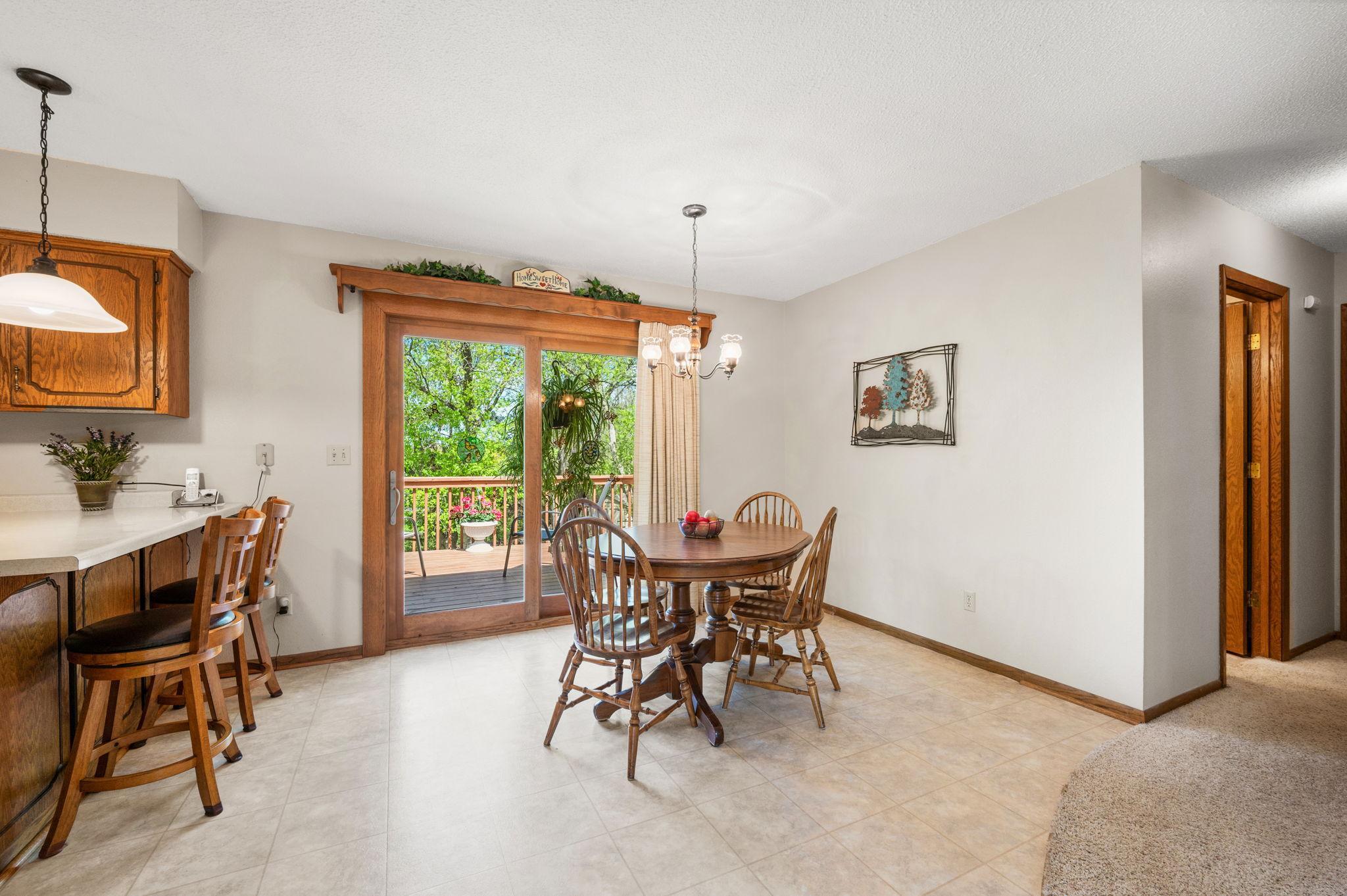 Step out from the dining room onto a private deck with breathtaking backyard views