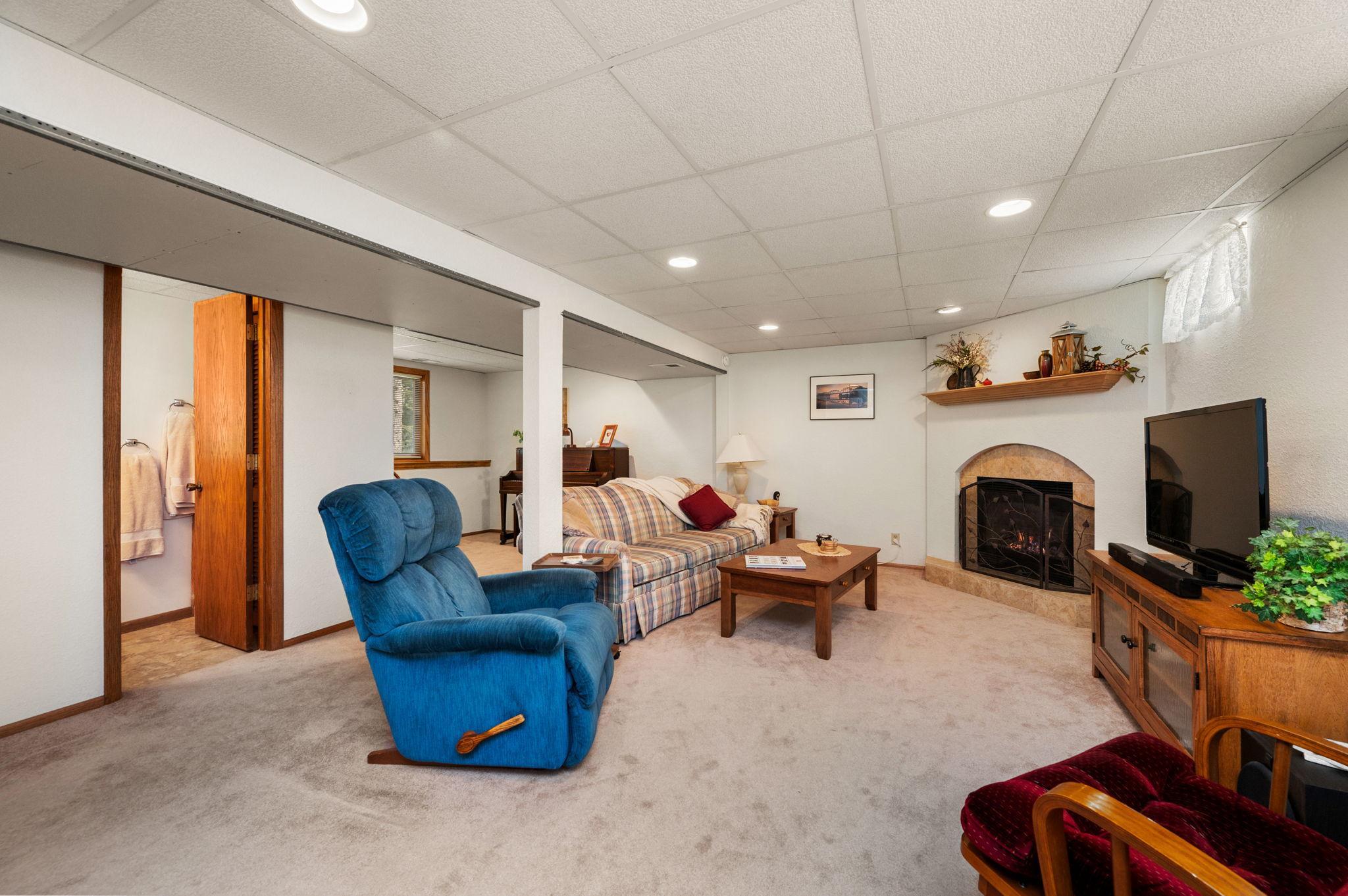 The finished walkout lower level includes a large family room with a cozy gas fireplace